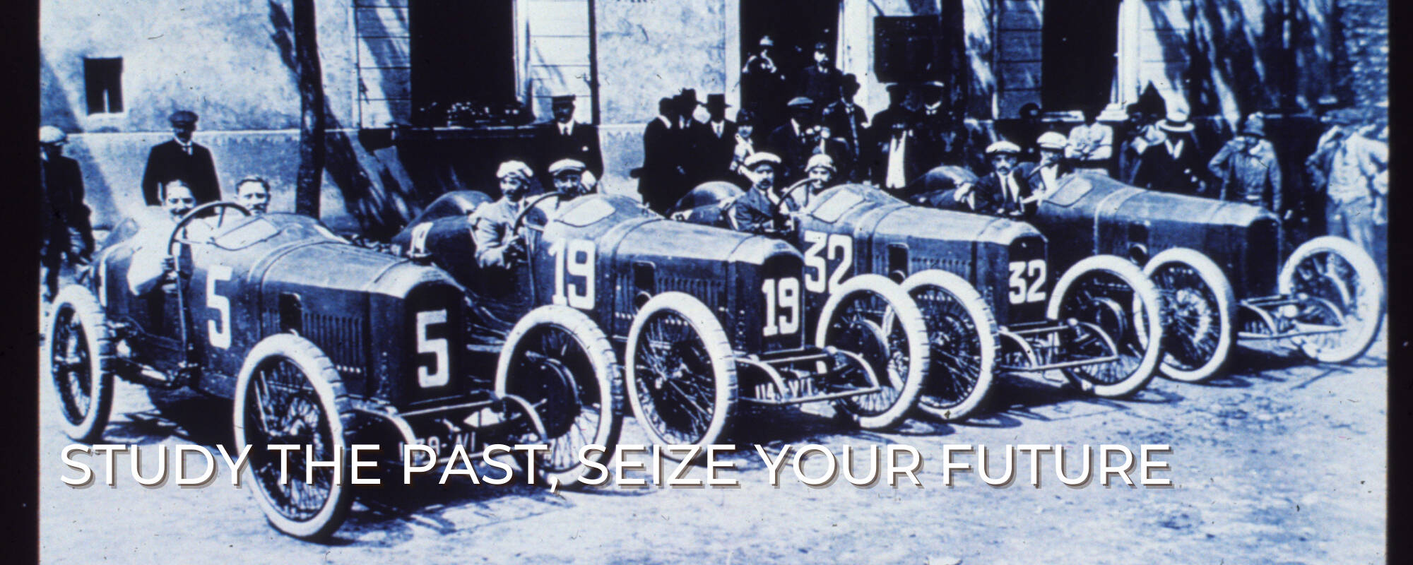 Race cars lined up in the early 20th century